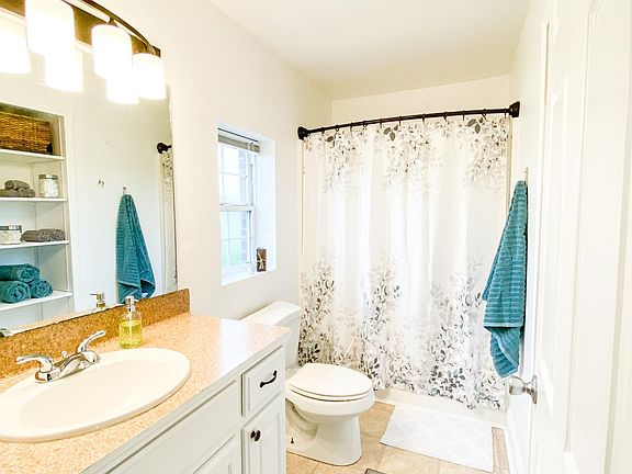 Bathroom- tub/shower, toilet, vanity, large mirror, built-in linen cabinet