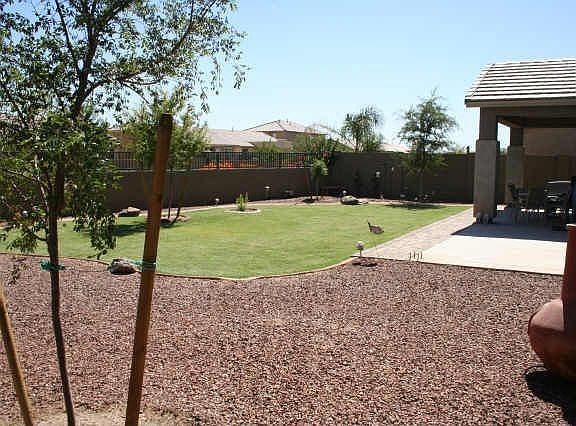 Custom landscaping and on a greenbelt lot; offers privacy galore!
