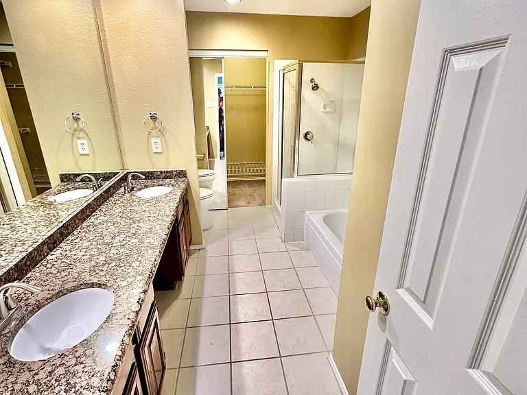 Master bath with walk in shower, separate tub, two sinks and walk-in closet, granite countertops.