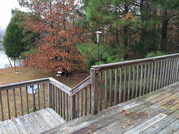 deck from living area, waterfront yard and woods on side