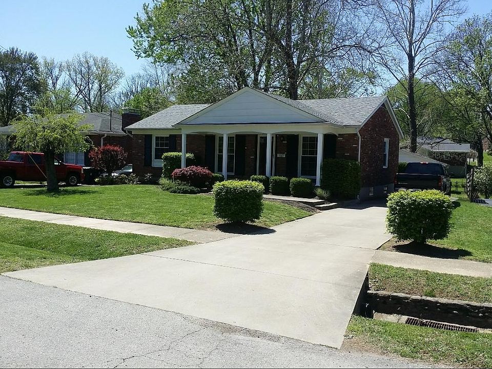 Beautifully landscaped front yard and covered porch.