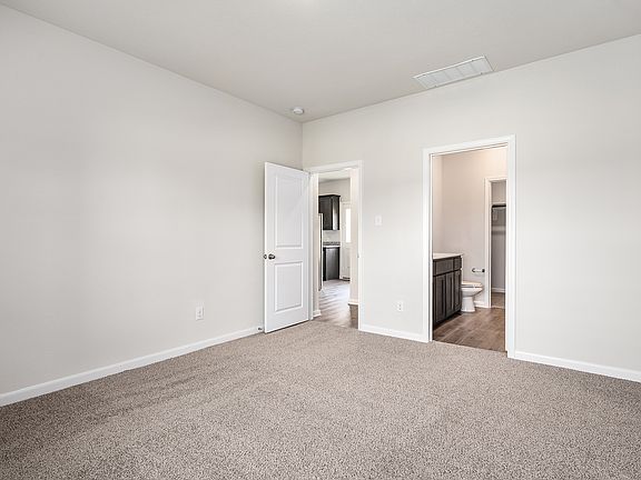 The master suite has a large bedroom, ensuite bathroom and a walk-in closet.