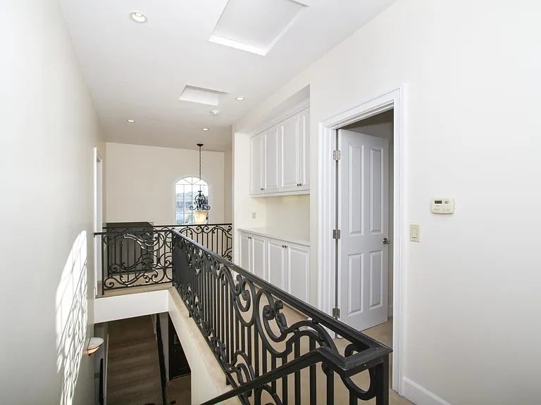 Upstairs Hallway with three Bedrooms, Linen Cabinet and French door leading to upper View Terrace.