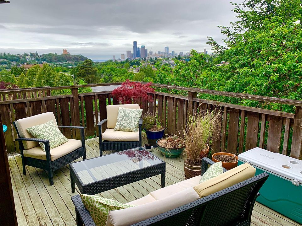Epic back deck view over a park looking at the city skyline and Olympic mountains beyond.