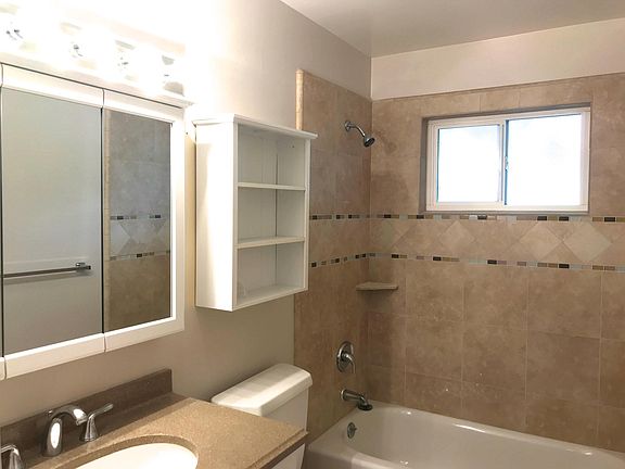 remodeled bath with porcelain tile and granite vanity 