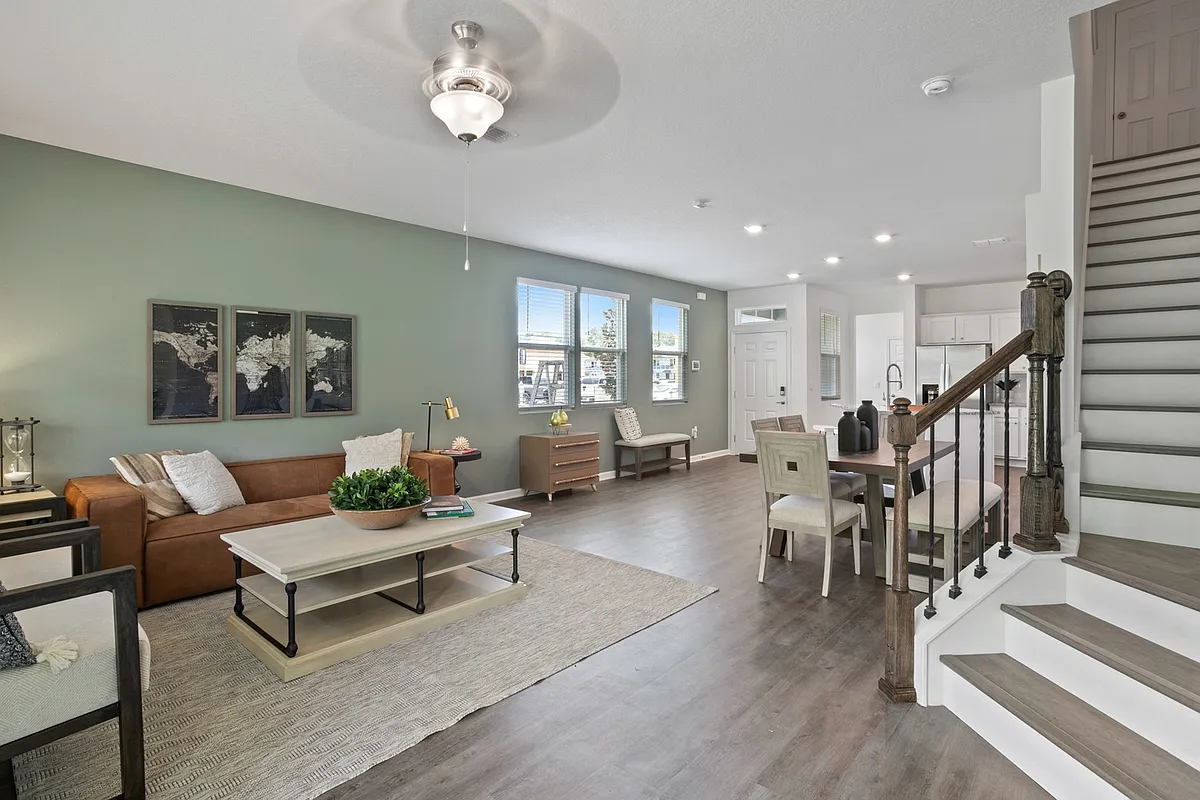 Photo 1 of 27 - Equinox West Townhomes - Jacksonville, FL Inviting Living Room and Open Kitchen - Equinox West Townhomes