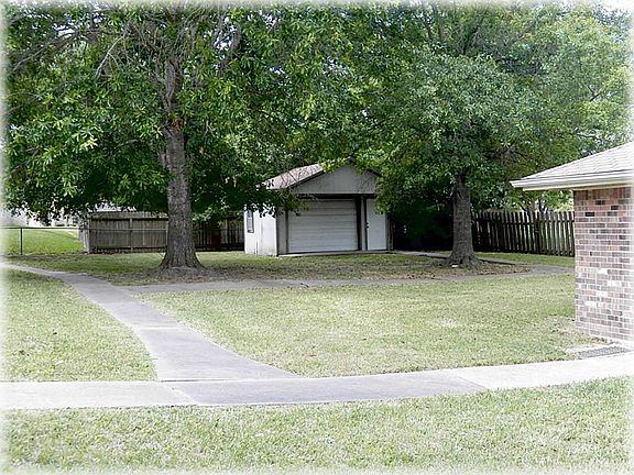 Walk ways lead from the house to the garage to the shed in the backyard & on to the covered back pat
