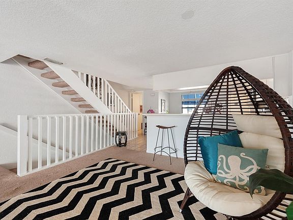 Living room stairs facing kitchen