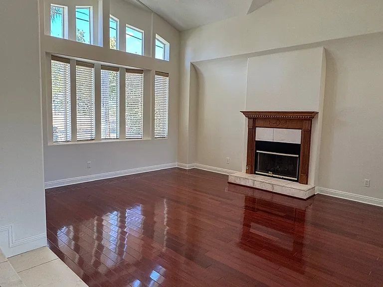 Living Room with High Bay windows, wooden flooring and Fireplace.