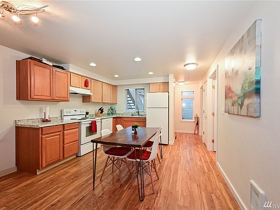 Large and open kitchen with beautiful laminate flooring and brand new countertops.