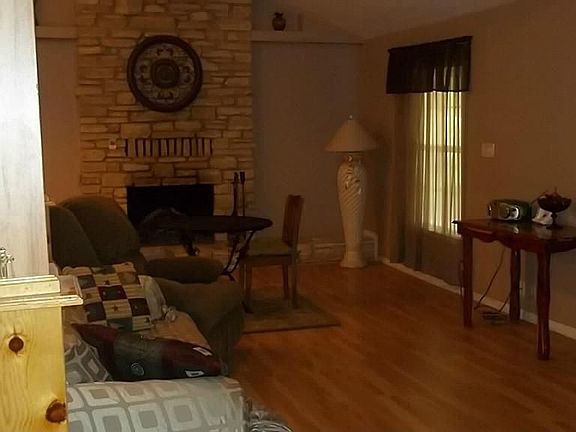 LIVINGROOM  - OPEN CONCEPT WITH WOOD-BURNING FIREPLACE,  AND FLOATING WOOD FLOORING