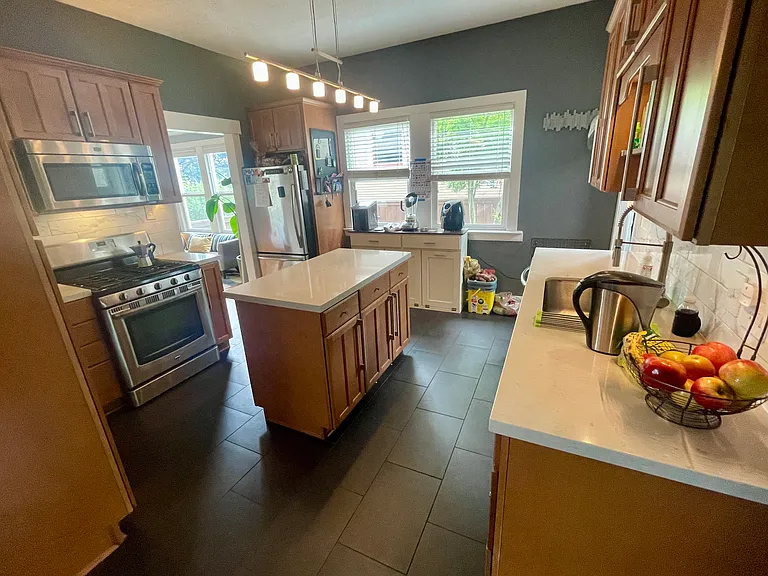 The kitchen flows into the dining room and the foyer.