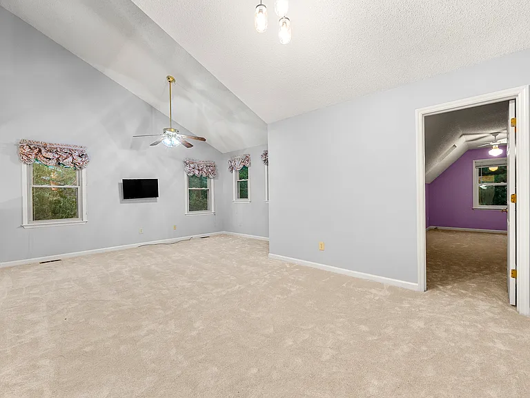 Upstairs living room. Door opening towards the third, smaller, bedroom.