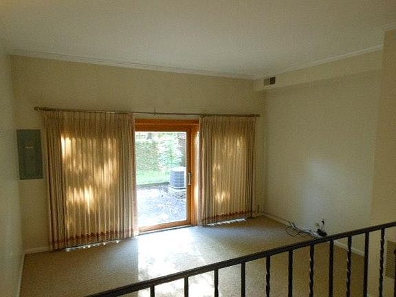 16'x13' Sunken living room has 9 ft. ceilings and a full wal