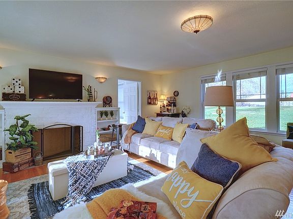 Spacious.  Comfy.  Cozy.  You'll love this front room/living room!  Original hardwood flooring, wood-burning fireplace with brick surround and wood mantle that is perfect for TV placement... Fabulous built-ins...  Fantastic window space/natural lighting and awesome private view! LOVE - LOVE - LOVE IT! Light and bright and soooo nice!  