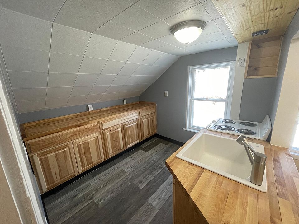 galley kitchen set up with pass through window with breakfast bar folding countertop