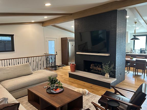 Family Room looking toward fireplace and kitchen in background. Smart TV with hard-wired internet, gas logs with remote.