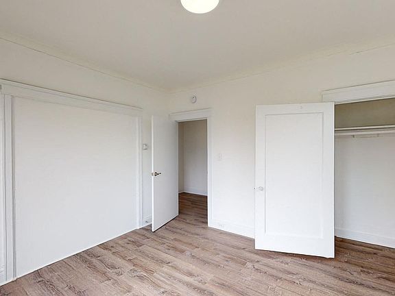 Bedroom with wood-like floor and a closet