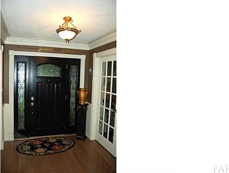 The welcoming entry foyer includes wood floors as well as Crown and chair rail molding.