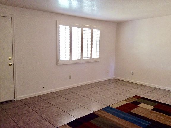 View 2 of Living Room that has Plantation Shutters