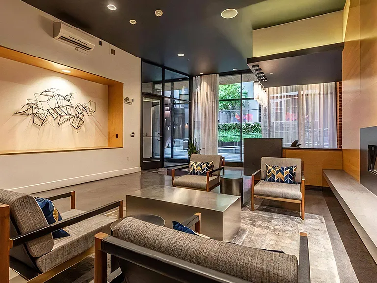 Entrance Lounge Area Featuring Glass Doors and Upholstered Chairs