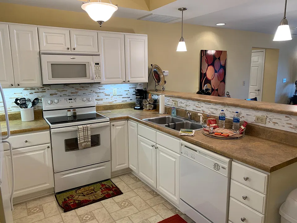 Kitchen with dishwasher, oven microwave and refrigerator.