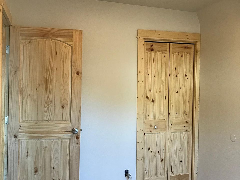 Bedroom 1 Solid pine entry and closet doors and trim. Custom tile floor. Nice bright natural light.