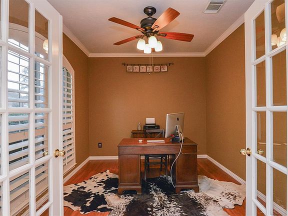 This exceptional study space is handsomely appointed with custom wall paint, high ceilings with fan, spotless flooring, and lovely plantation shutters.