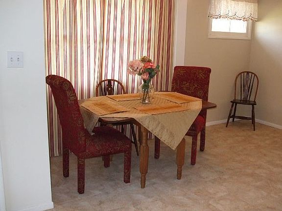 Intimate dining area looks out to living room and fireplace