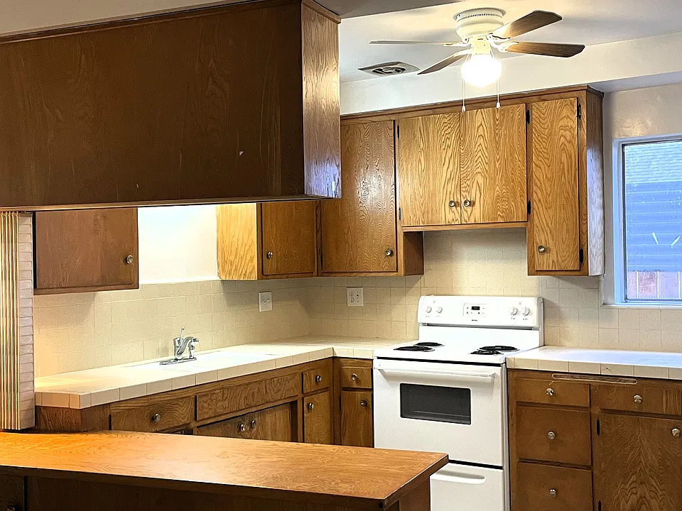 Usable cooking kitchen... comes with an cooktop/oven, refrigerator, new fan, lots of cabinetry and more!