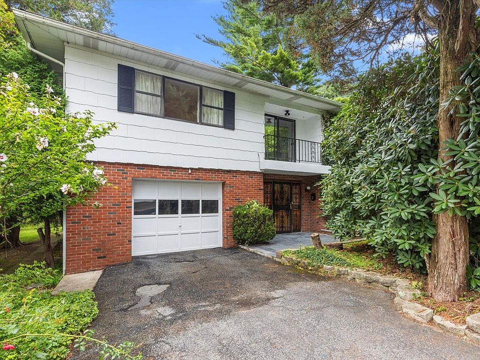 Front of the property featuring a driveway and garage.
