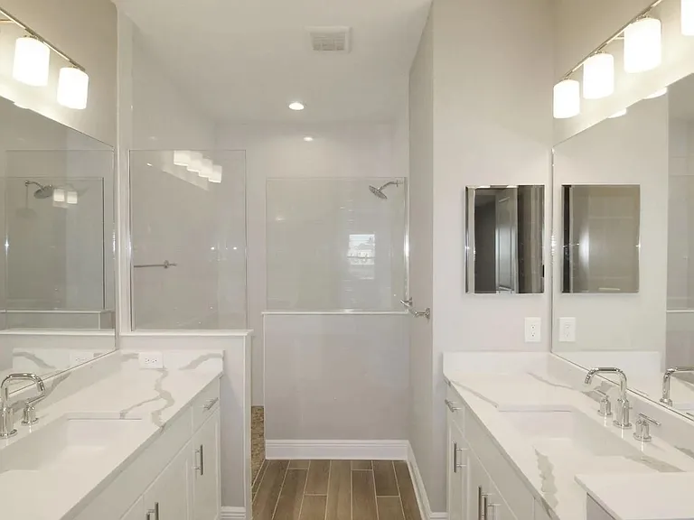 The primary Bath features his & her vanity & sink, a huge walk-in shower, and an amazing double door entry to the fabulous walk-in-closet!