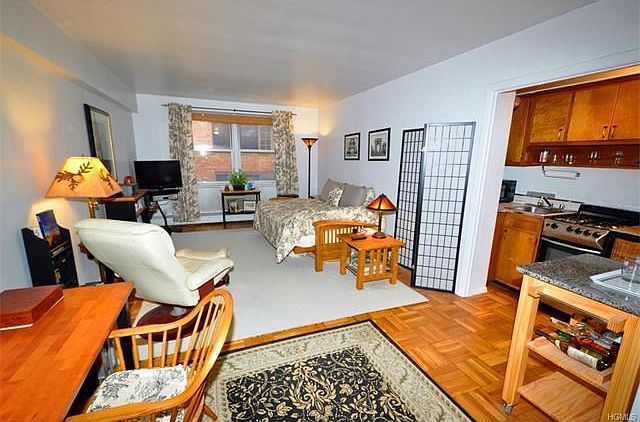 The spacious living room has parquet floors.