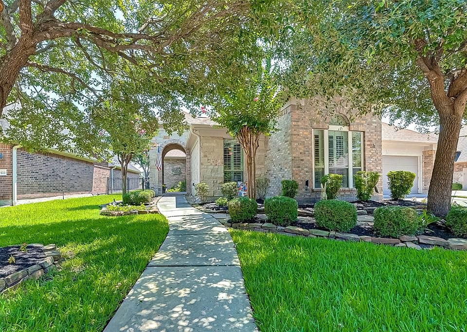 Beautiful traditional brick home with mature trees and landscaping