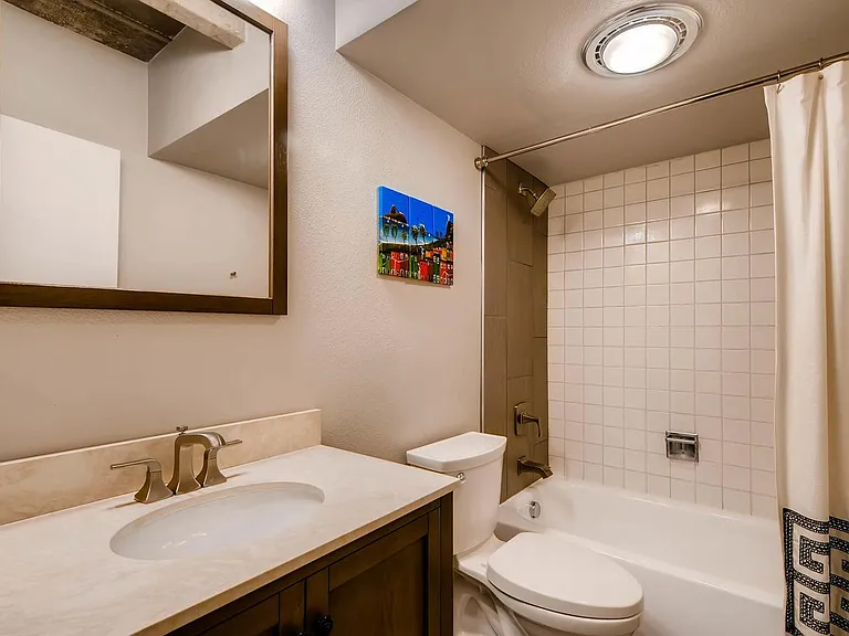 Hallway bathroom with tub/shower combo.