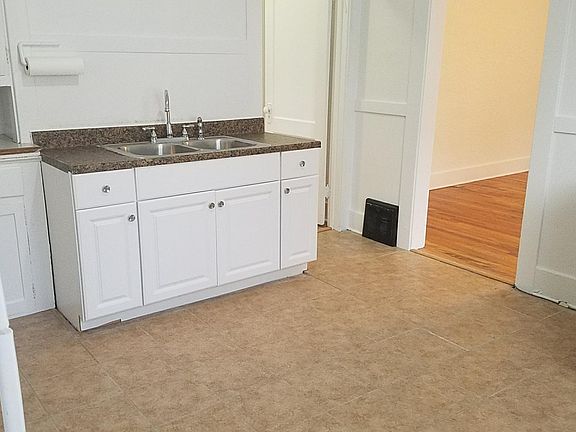 Kitchen being remodeled to include dishwasher, washer, dryer, gas range, disposal and hardwood countertop.