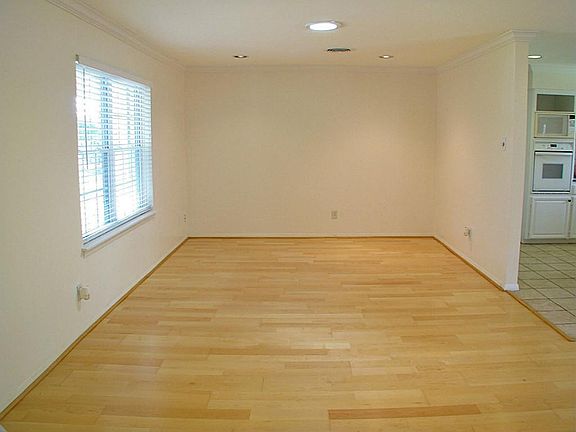 Wood flooring covers the living areas and all of the bedrooms. Crown molding runs throughout most of the home.