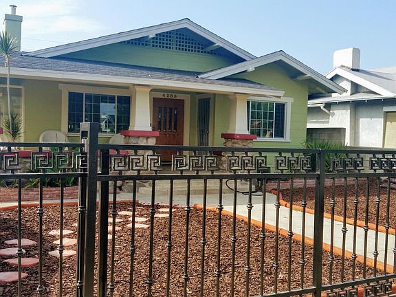 Harvard front view with decorative wrought iron security gate.