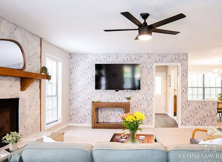 This newly remodeled space is a masterclass in mid-century modern design. Clean lines, natural light, and carefully selected pieces come together to form an elegant and functional living area.