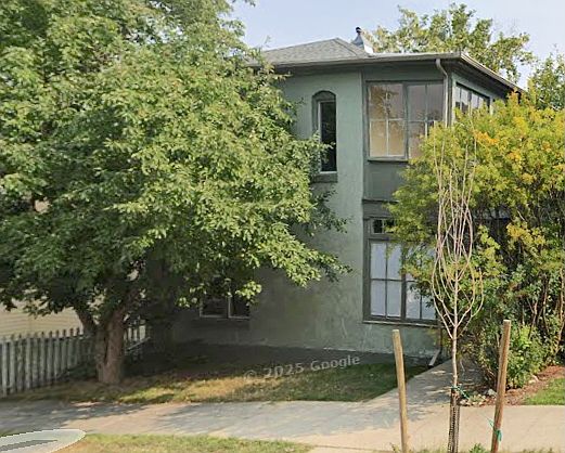Streetside view. Front door to the right, shared with downstairs tenant. Sidewalk leads to an ample back yard. This apartment includes the entire second floor, including sunspace above porch. This is a nice quiet neighborhood!