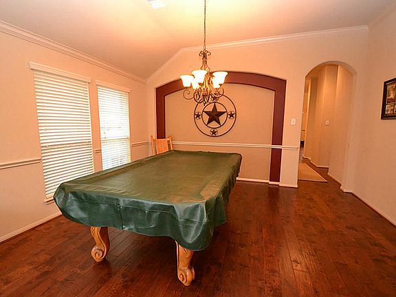 Dining room enhanced by hand scraped hardwood floors, raised ceilings, crown molding, chair rails an