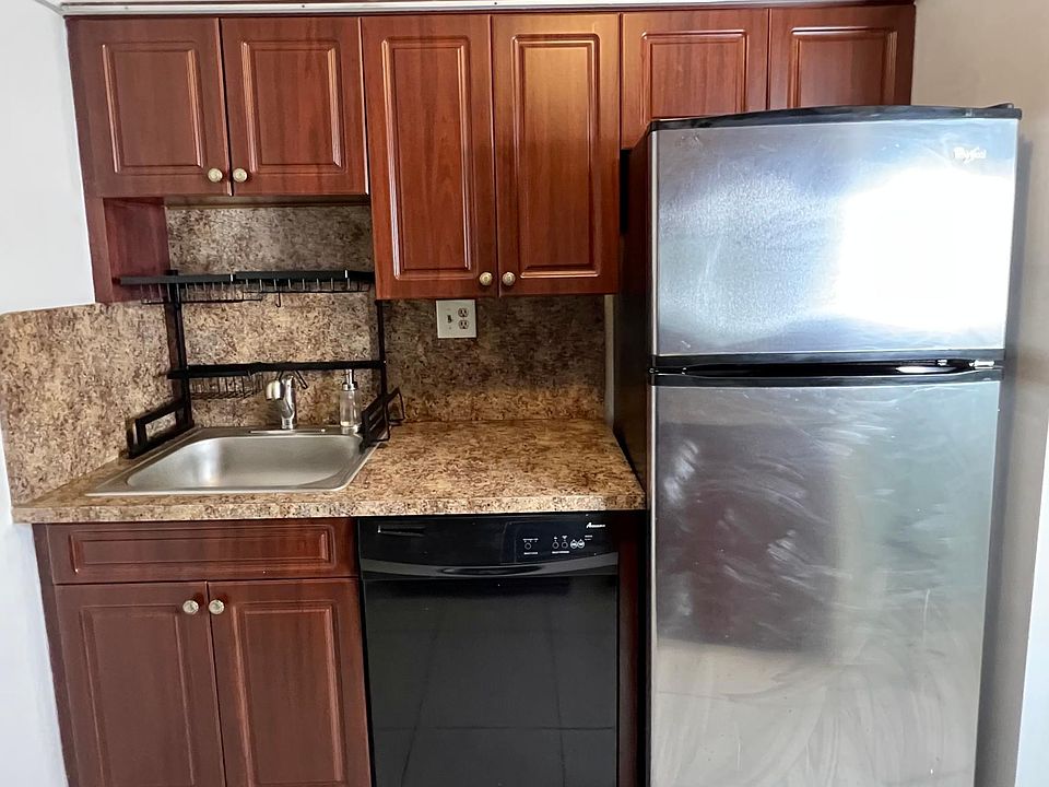 STAINLESS STEEL REFRIGERATOR AND SINK WITH BLACK DISHWASHER