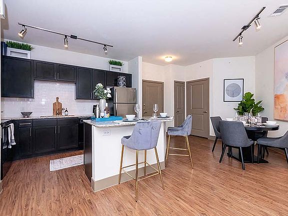 Upgraded kitchens include premium granite countertops and stainless steel appliances