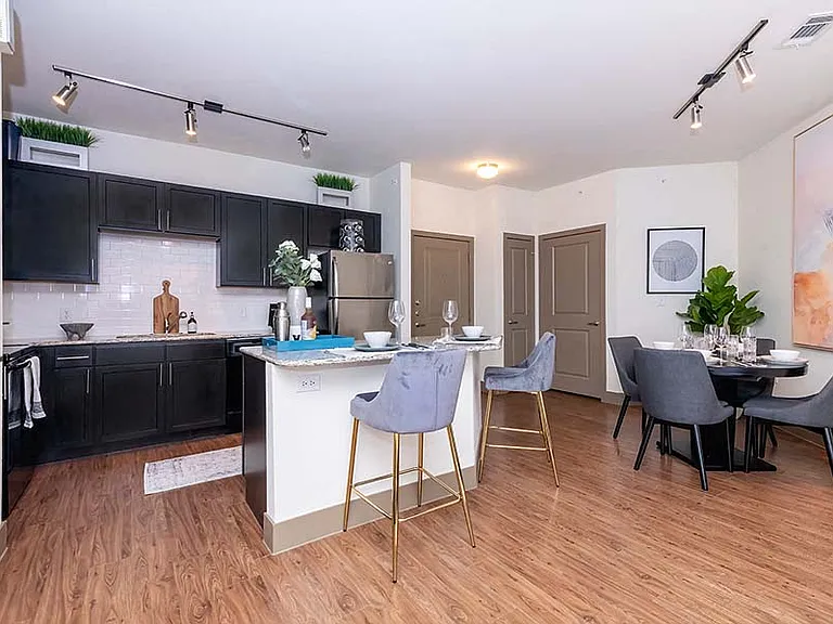 Upgraded kitchens include premium granite countertops and stainless steel appliances