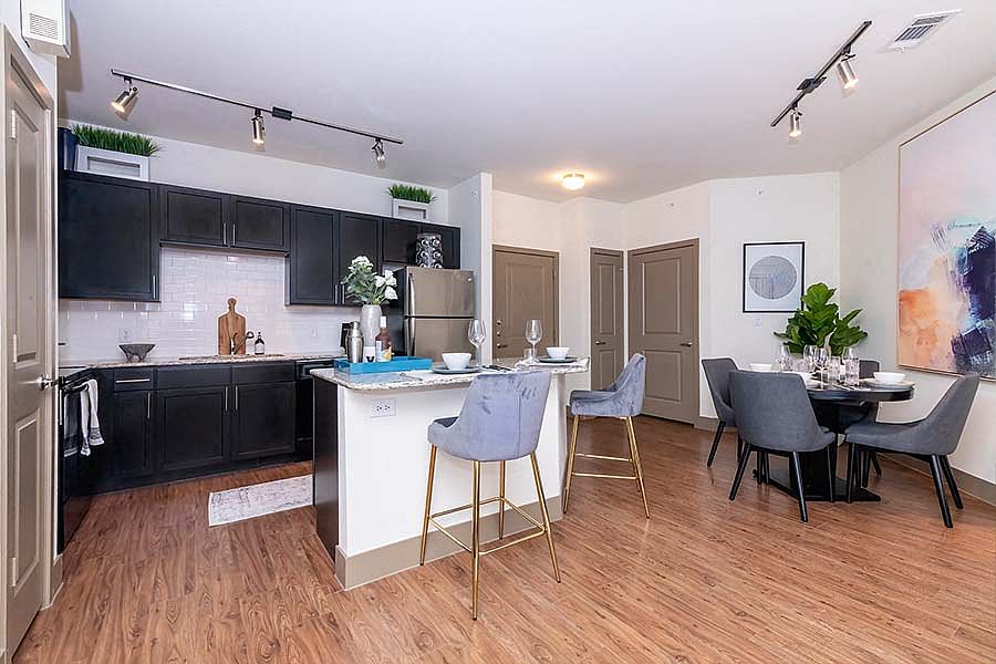 Upgraded kitchens include premium granite countertops and stainless steel appliances