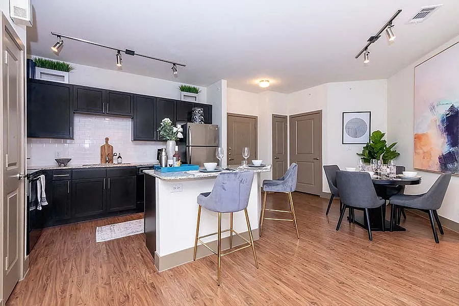 Upgraded kitchens include premium granite countertops and stainless steel appliances