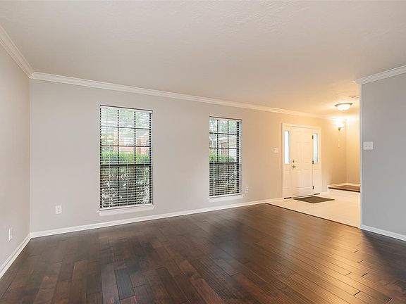 To the right of the entry is this large living space - a perfect spot to set up your home office or your big-screen TV or pool table! The flooring is engineered hardwood.