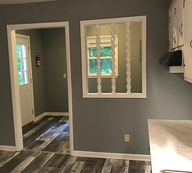 Looking from Kitchen into the Utility Room with window. Back entrance door.
