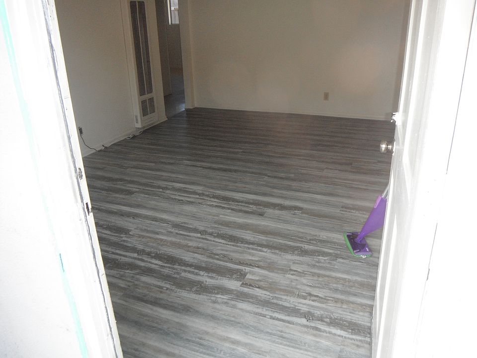 Living room with new flooring through front door.