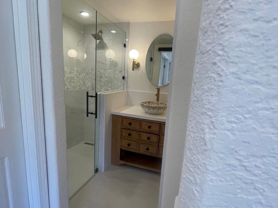 Newly remodeled bathroom with quartz, tile, and lots of storage space.